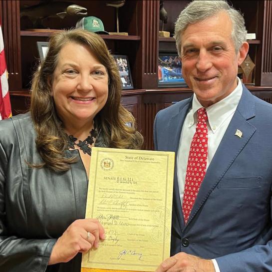 A man and a woman holding a certificate together