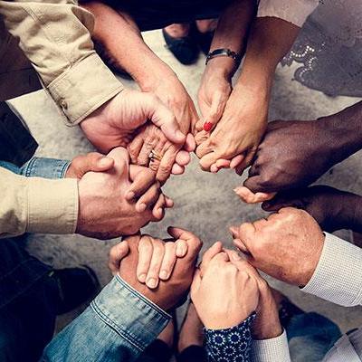 a group of people holding hands