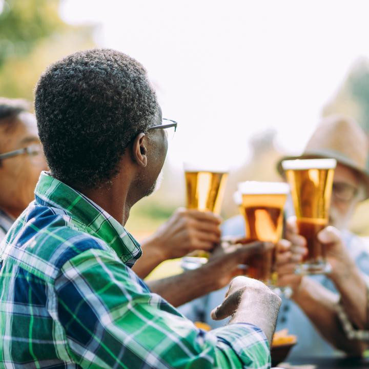 Seniors toasting each other with glasses of beer