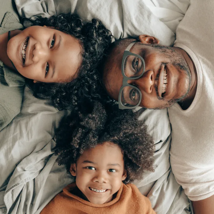 A dad wearing glasses plays with his 2 kids as a reminder as to why he wants to protect his vision from diabetes