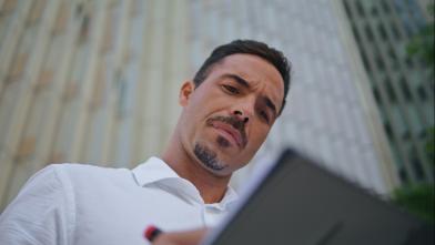 A man writing on a clipboard.