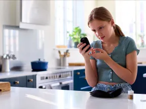 Young girl checking her blood glucose with meter