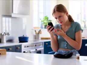 Young girl checking her blood glucose with meter
