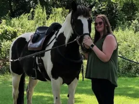Alysa standing with her horse