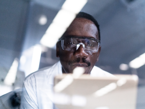 African American researcher looking at computer