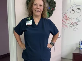 Photo of Marlena standing in a Nurse's uniform