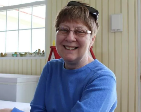 Photo of Kaye sitting in a chair