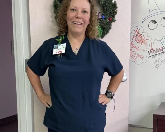 Photo of Marlena standing in a Nurse's uniform