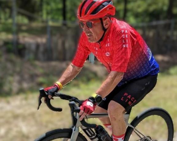 Don riding a bicycle on a road