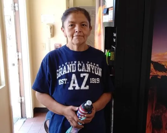 A woman standing next to a vending machine