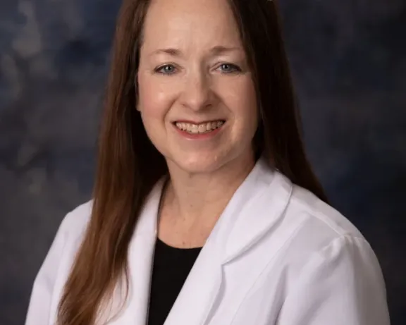 Photo of woman in white coat