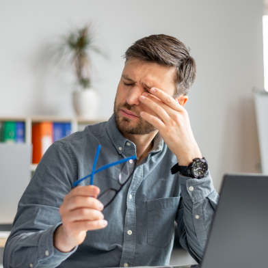 A man rubs at his dry eyes caused by diabetes related dry eye syndrome