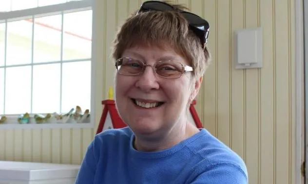 Photo of Kaye sitting in a chair