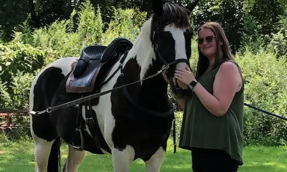 Alysa standing with her horse