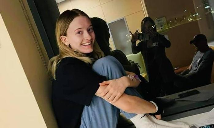 Photo of Ulyssia sitting with her legs folded to her chest