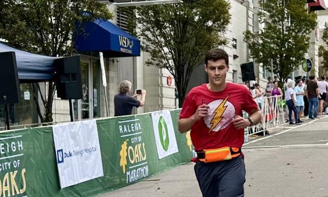 Photo of Robert crossing a marathon finish line