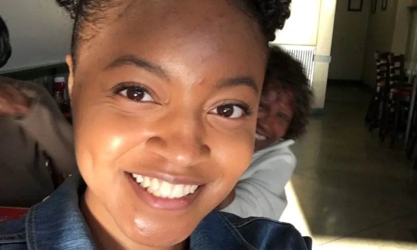 Woman taking a selfie and smiling at the camera