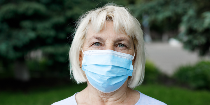 An old woman wearing a mask
