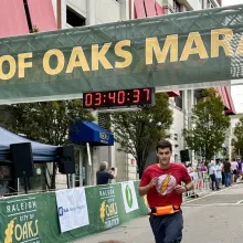 Photo of Robert crossing a marathon finish line
