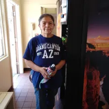 A woman standing next to a vending machine