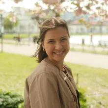 a smiling girl with brown hair on a spring day