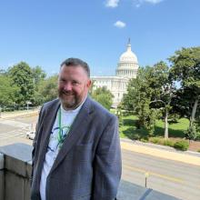 Man standing in front of U.S. Capitol Building.