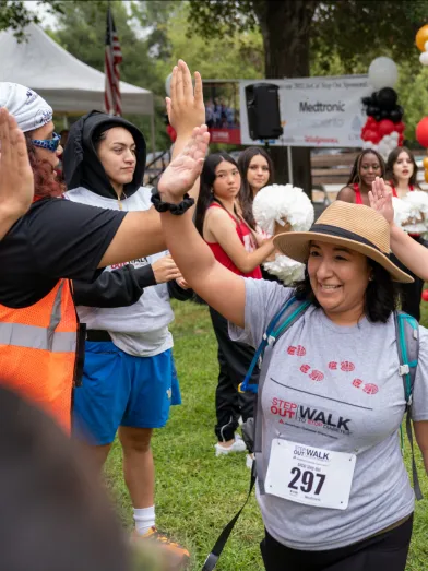 People in a community giving high fives after Step Out Walk
