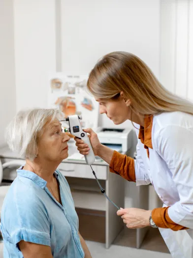 A doctor checks the eye pressure of a senior woman for diabetic eye disease