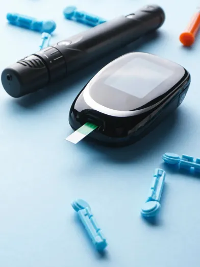 Blood glucose meter with test strip, lancing device, and lancets.