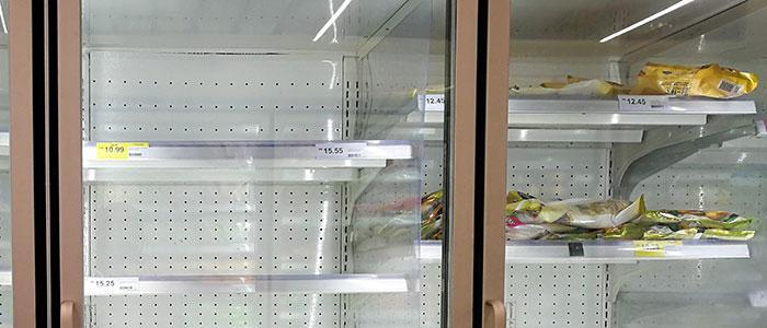 Food section in grocery showing nearly bare shelves